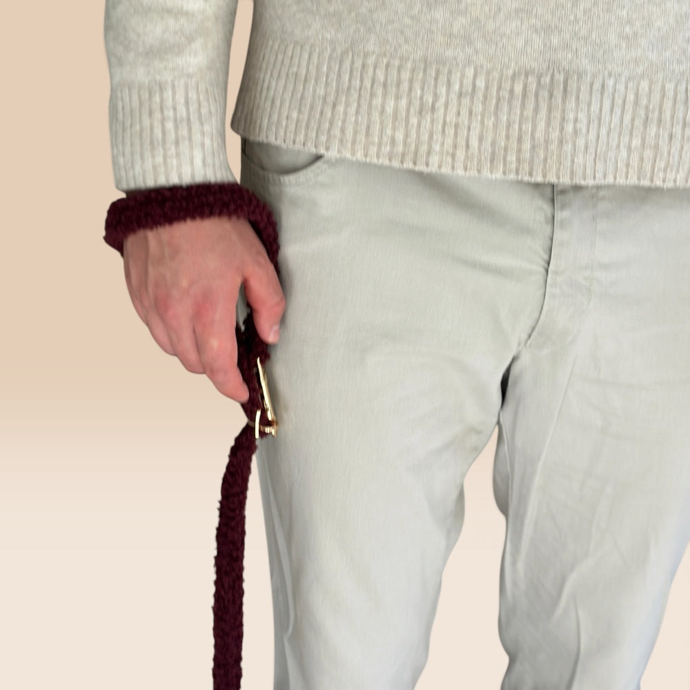 a dark burgundy fuzzy teddy dog leash with a gold-tone clasp. The teddy multifunctional leash has white text reading TRUFOIS.
